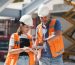 Civil Engineers Checking Works According To Project Using Digital Tablet At Construction Site